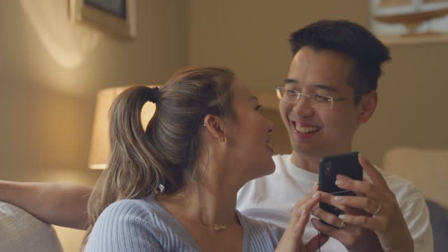 couple laughing looking into the phone