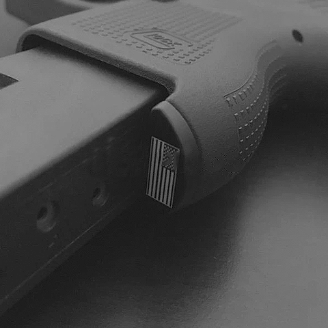 Close-up of a pistol grip with an American flag inlay, a Glock upgrade accessory