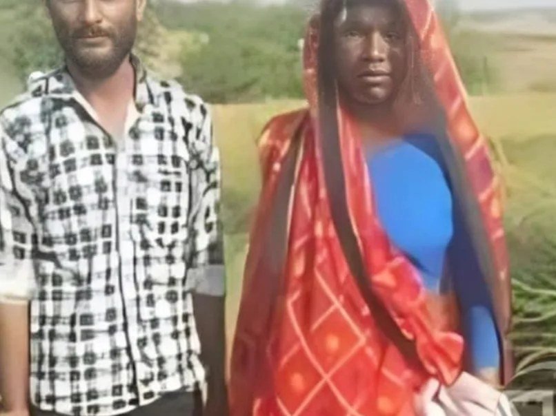 Omvati Devi in her red saree standing beside the railway line in Etah