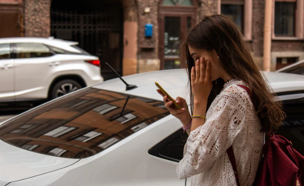 Smiling woman reading a text message on her smartphone